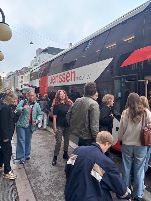 en gruppe mennesker som står utenfor et tog