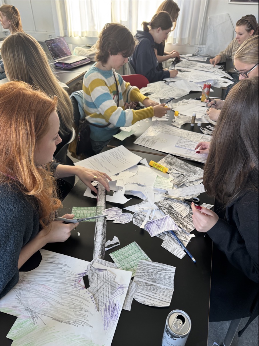 en gruppe mennesker som sitter ved et bord med papirer på