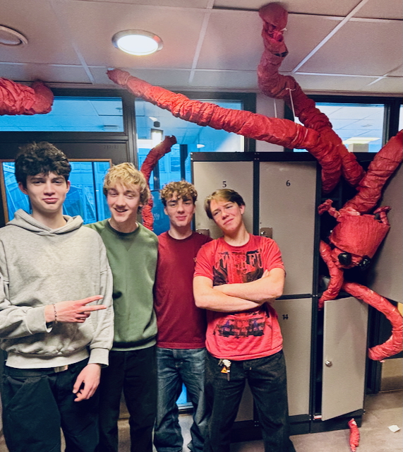 en gruppe barner som poserer for et bilde med en person i et plagg