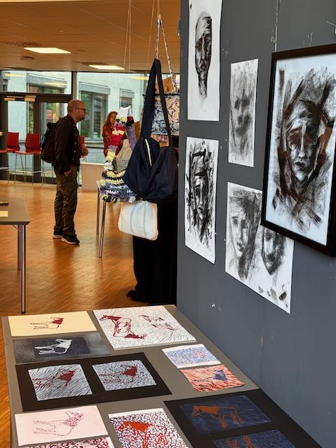 en person som står ved siden av en vegg med kunst på