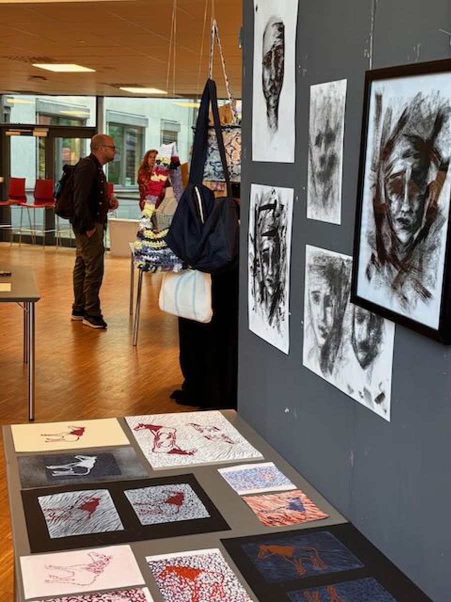 en person som står ved siden av en vegg med kunst på